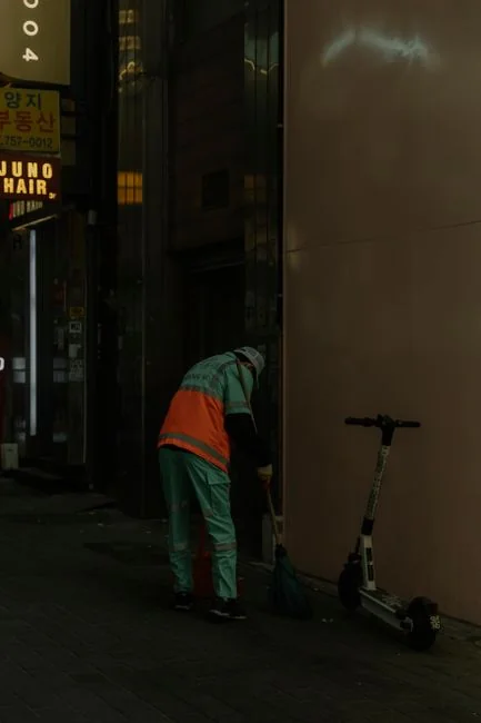 An individual disinfects a workspace using fumigation, wearing full protective gear for safety.